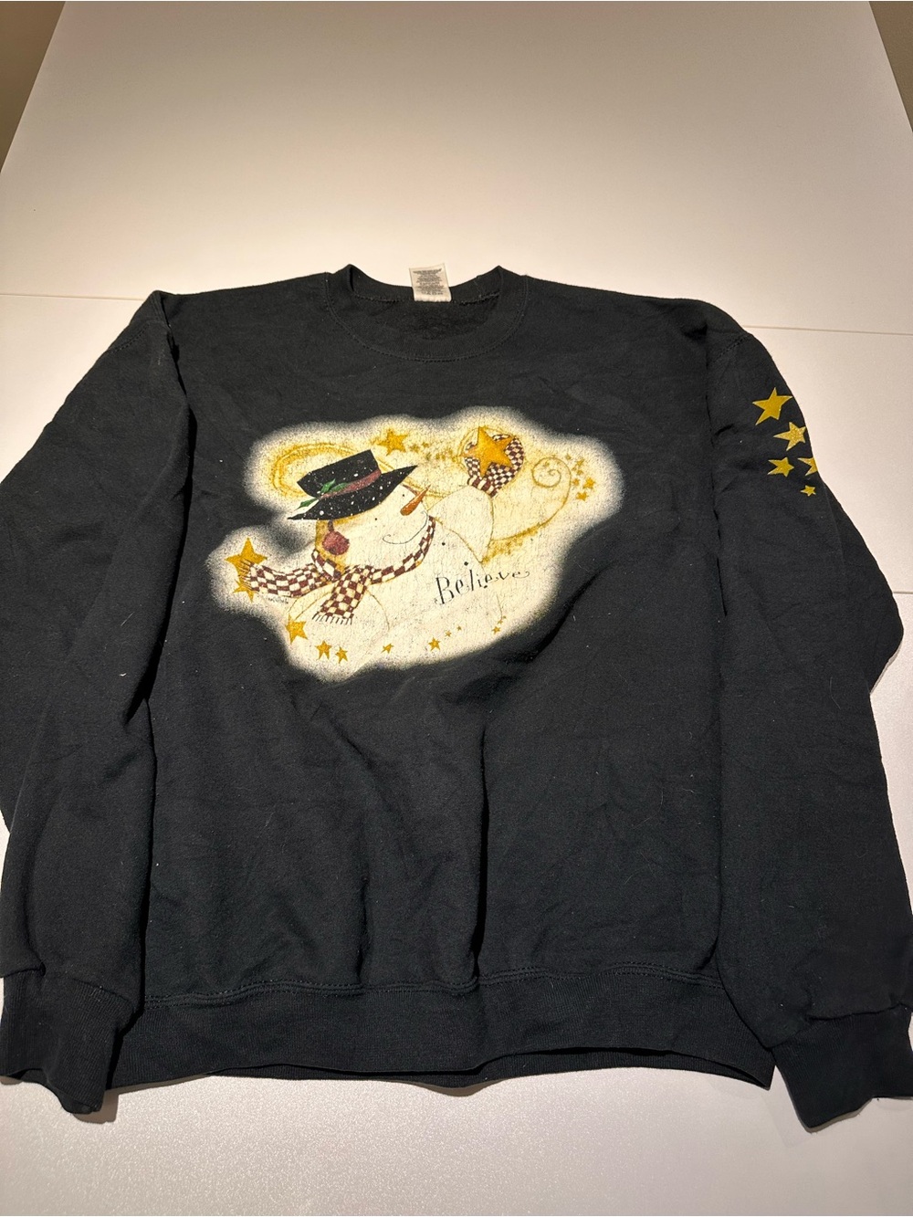 Jerzees Black Crewneck Sweatshirt with Snowman 'Believe' Graphic and Gold Stars
